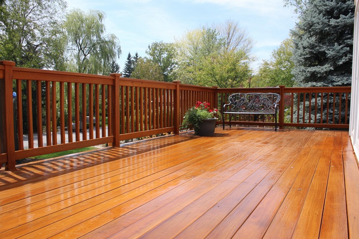 How to Stain a Deck: Complete Guide for Homeowners 4 Completed professionally stained deck showing even color, well-feathered edges, and quality finish